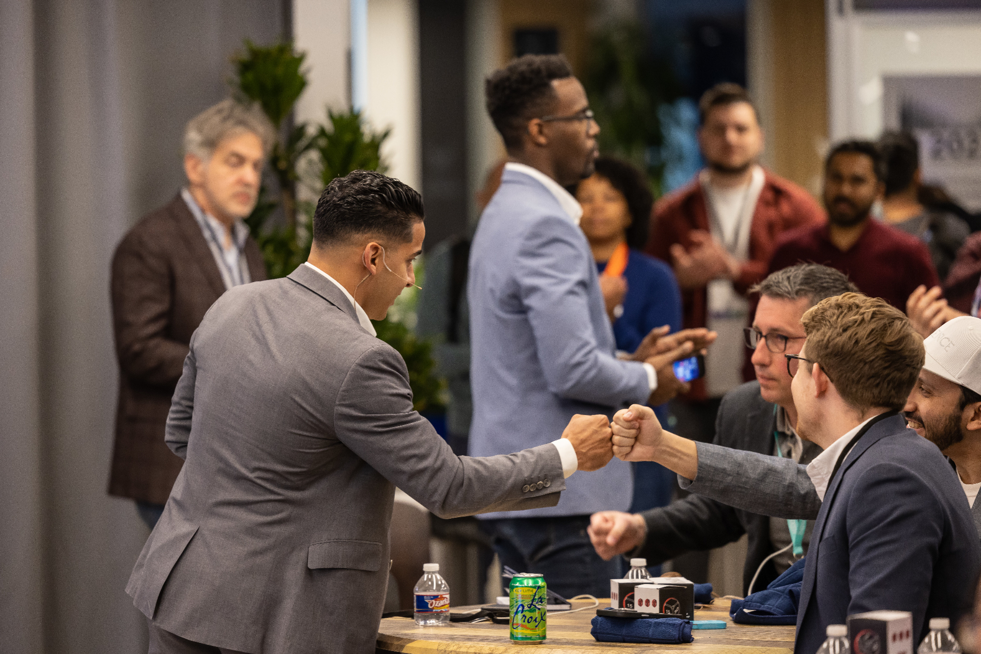 Two attendees sharing a fist bump at a GCOAT event